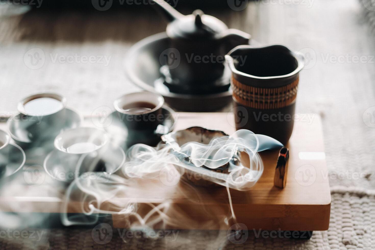 Tea ceremony with smoking incense. Incense stick and tea ceremony photo