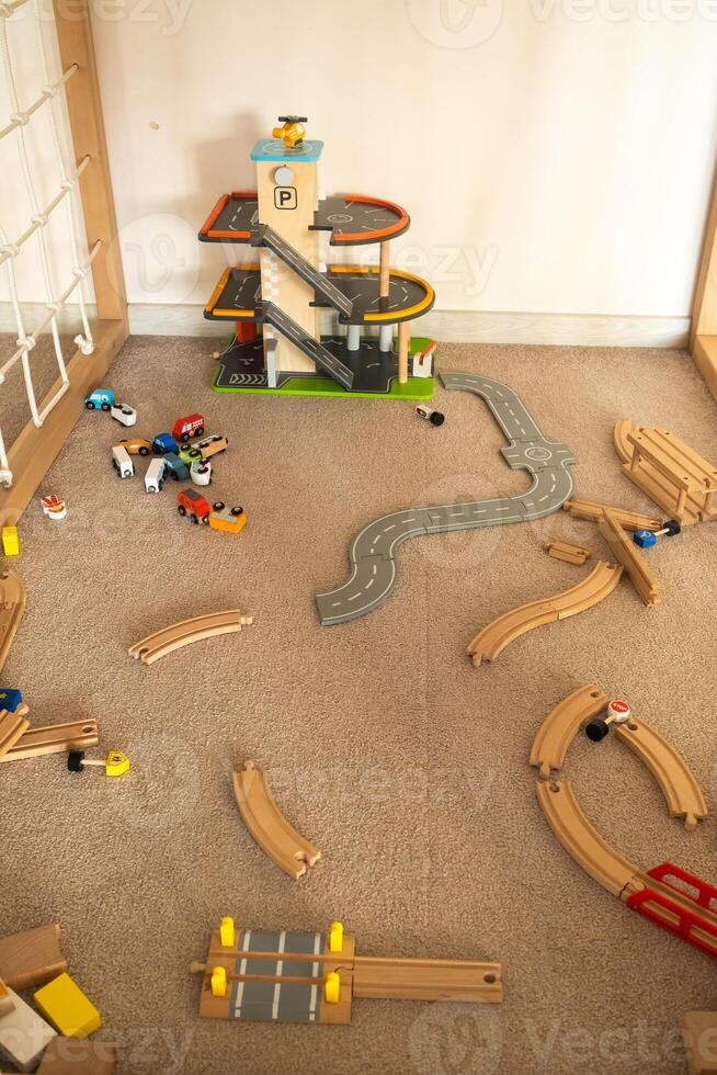 A scattered wooden road construction kit on the floor. Child's play photo