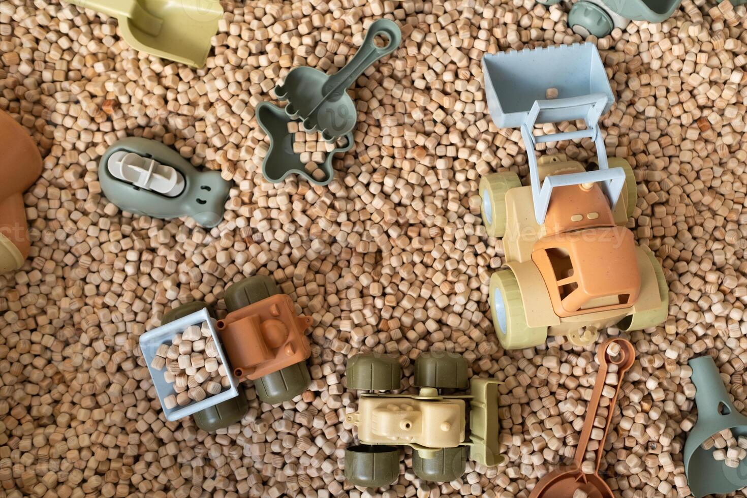 A modern children's sandbox with toys. Sandbox filler in the form of wooden small wooden cubes photo