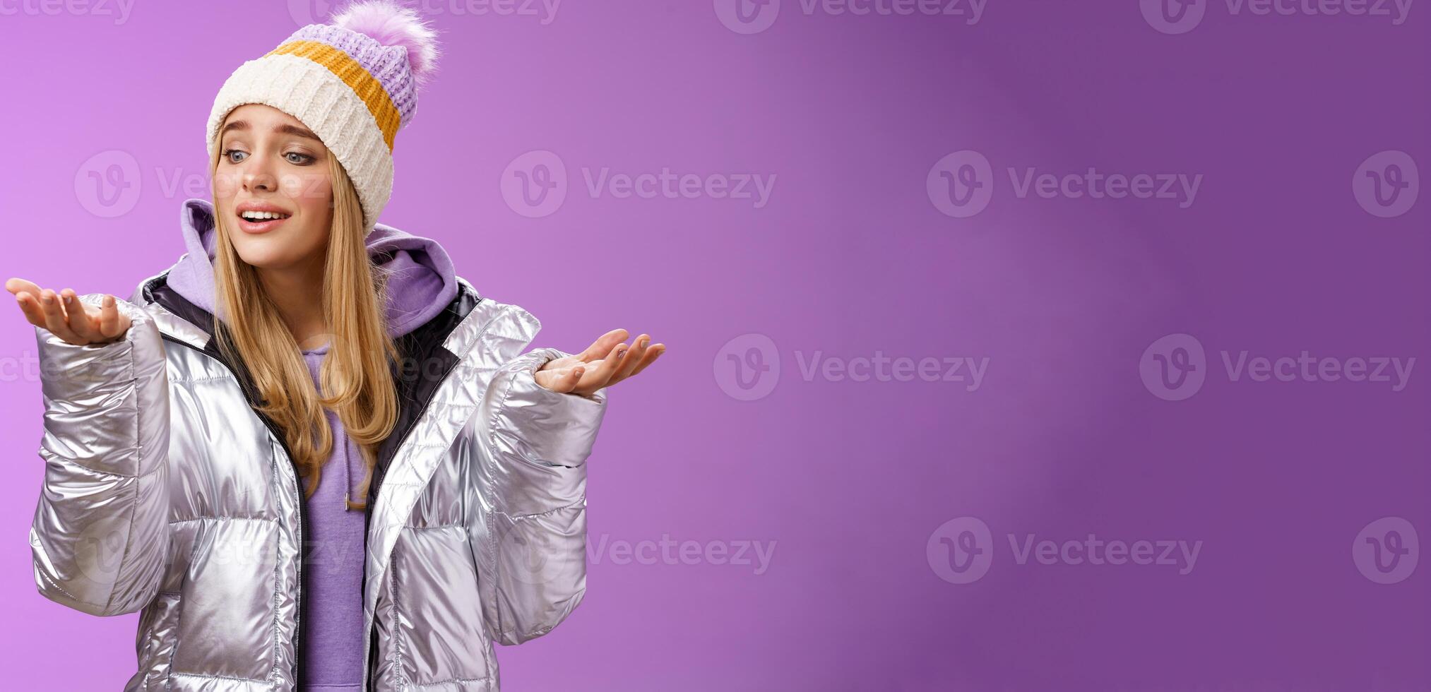 Delighted caring lovely young blond woman looking snowflake drop palm glancing hand tenderly smiling cherish nice moment enjoying winter snowy day standing pleased purple background photo