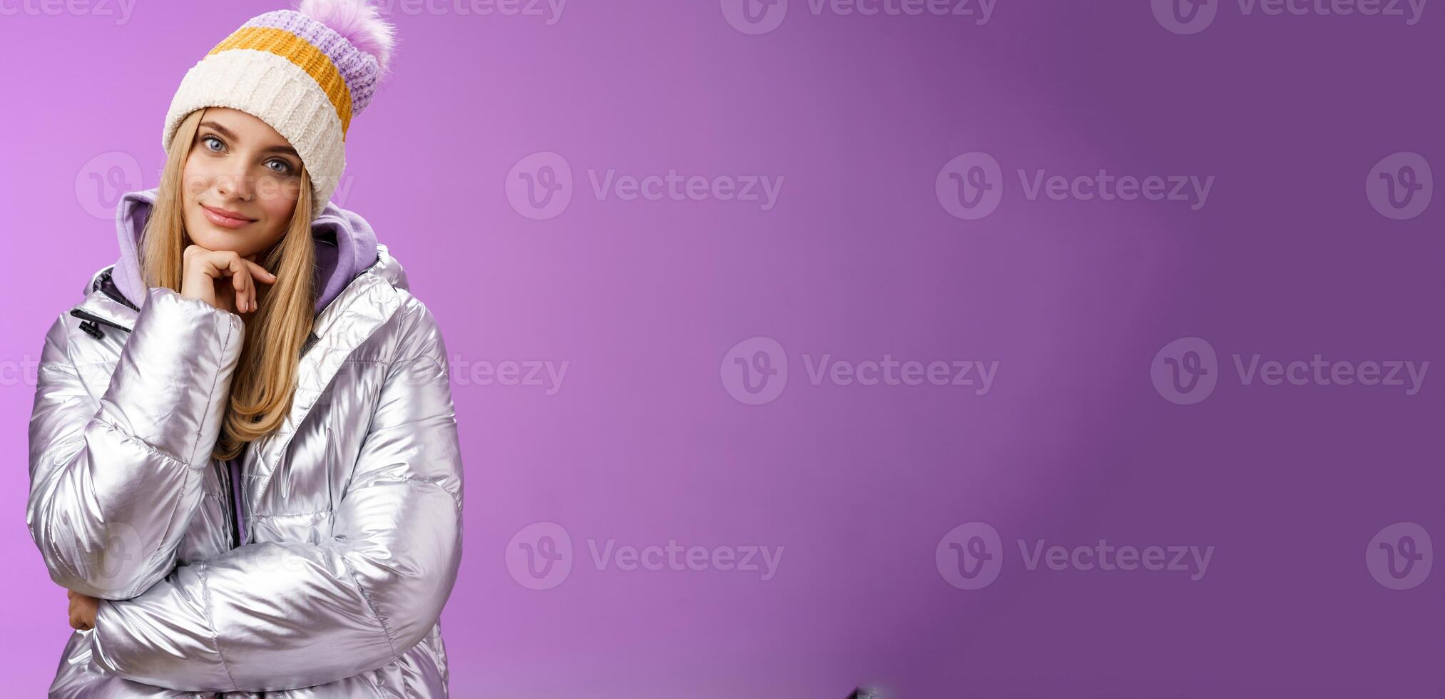 Flirty curious attractive creative blond girl tilting head smiling amused find excellent idea touch chin thoughtful thinking standing interested looking intrigued camera in silver outdoor jacket photo