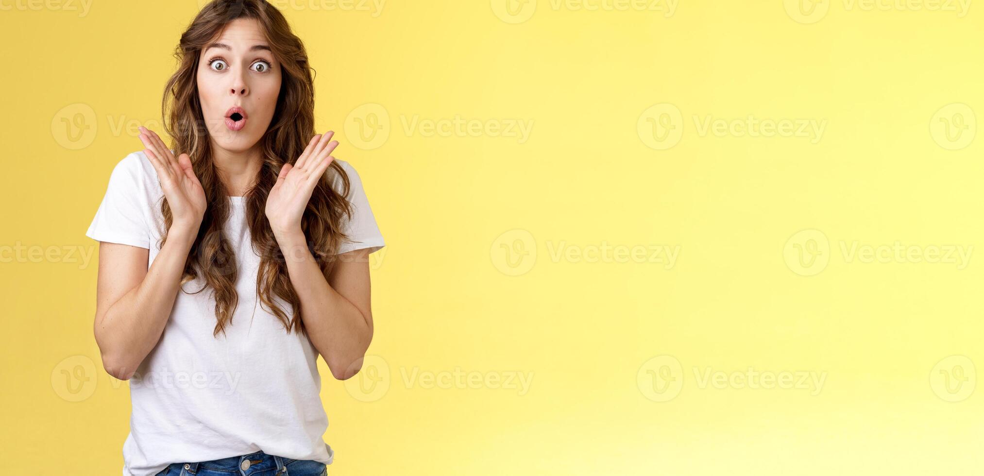 Shocked impressed surprised girl learn interesting pleasant good news clap hands open mouth fold lips wow gasping stare intrigued enthusiastic reaction awesome performance yellow background photo