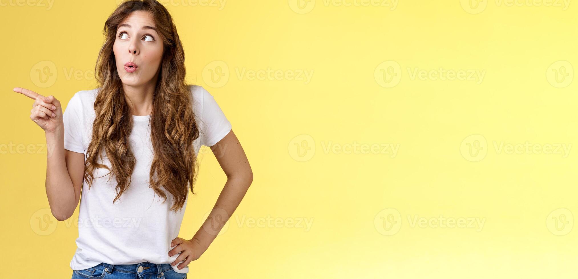 Surprised girl admire awesome offer fold lips intrigued wow sound observe interesting scene pointing staring curiously upper left corner check-out cool promo showing friend new menu favorite cafe photo