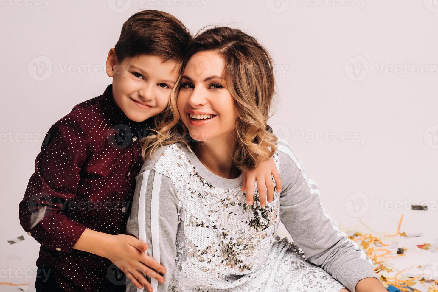 Portrait of a happy mother and son on a white background photo