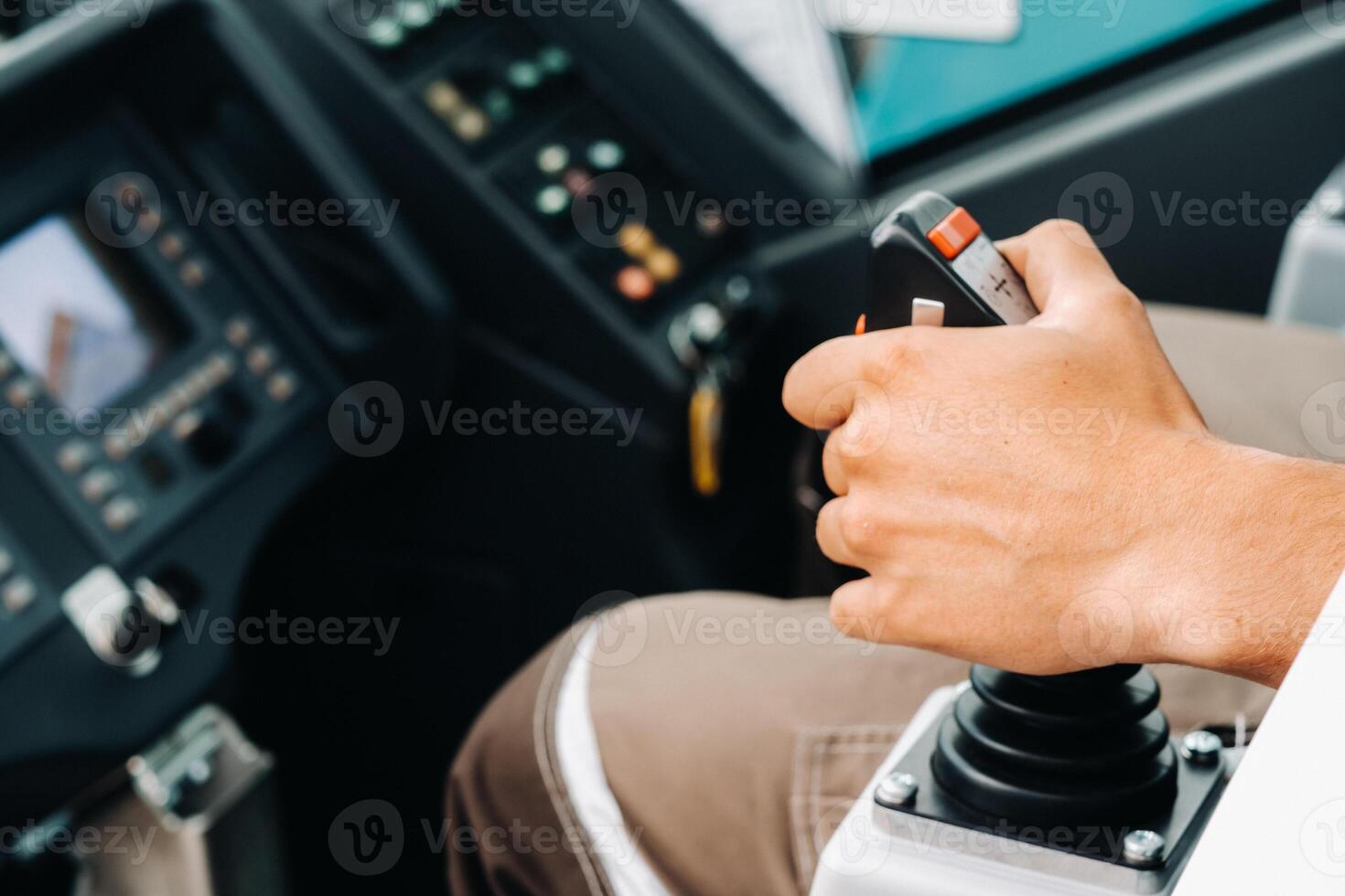 Close up of a hand holding the control stick and ready to work in the truck crane the largest truck crane for challenging tasks photo