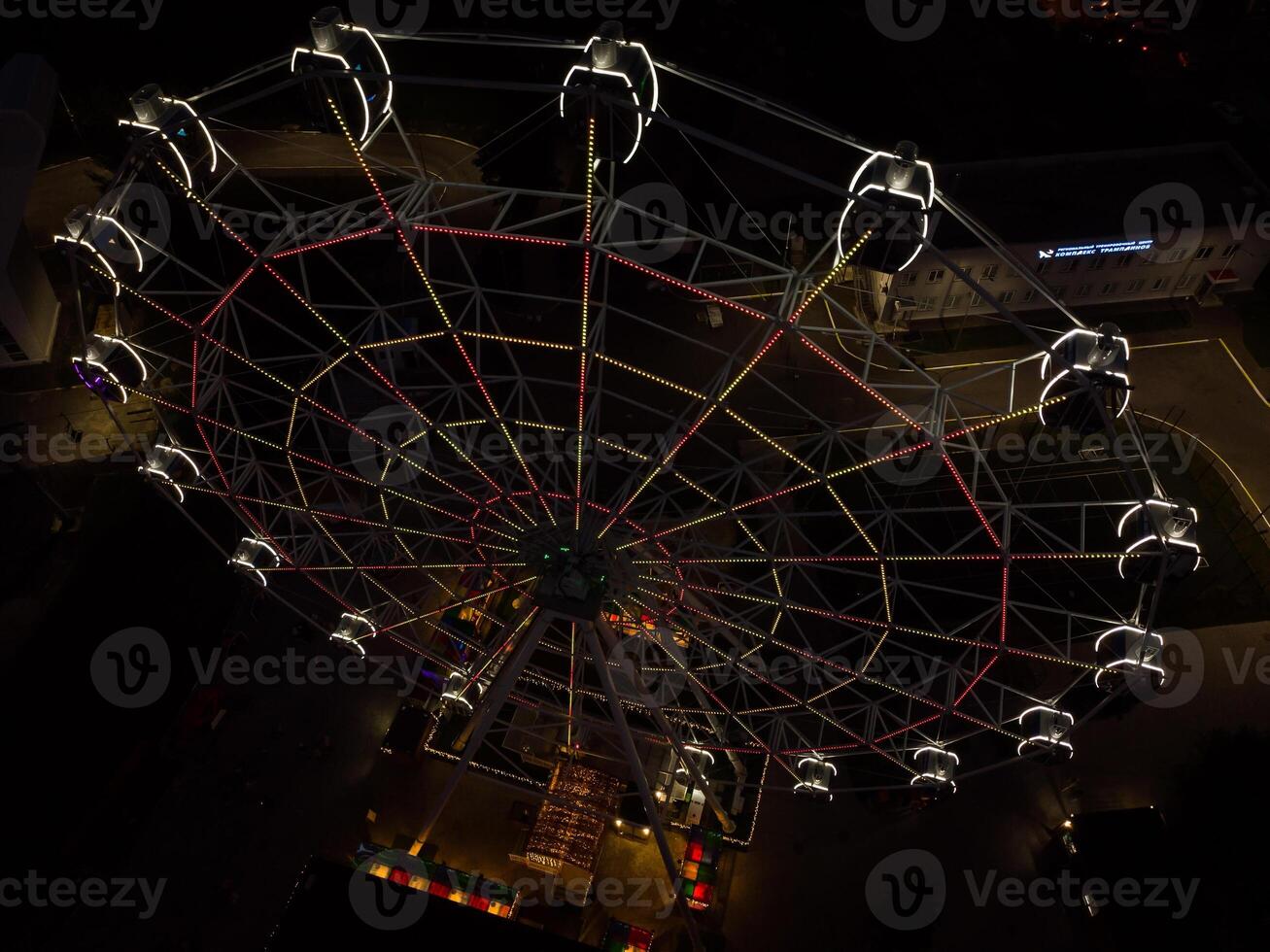 Beautiful sunset over the city with a lighted Ferris wheel. photo