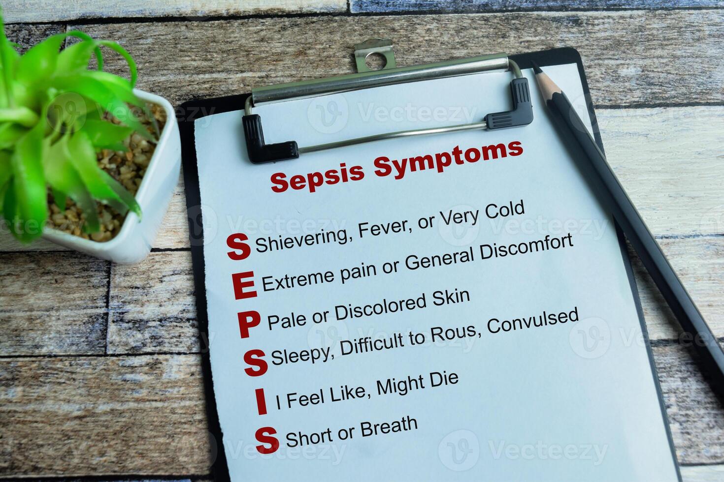 Concept of Sepsis Symptoms write on paperwork with keywords isolated on wooden background. photo