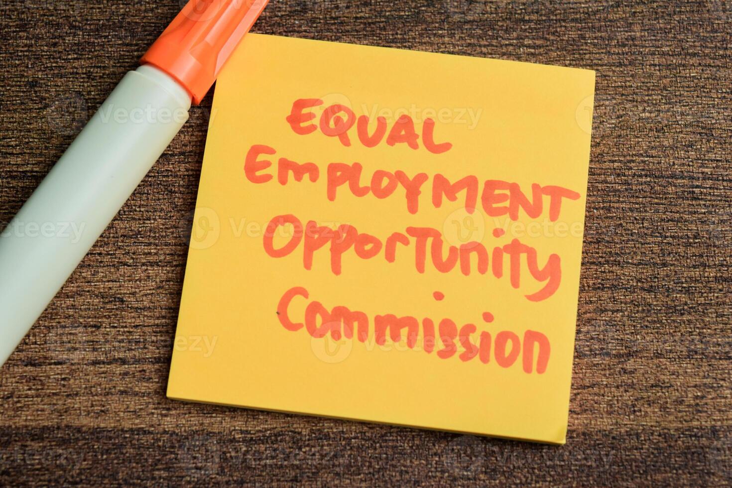 Concept of Equal Employment Opportunity Commission write on sticky notes isolated on Wooden Table. photo