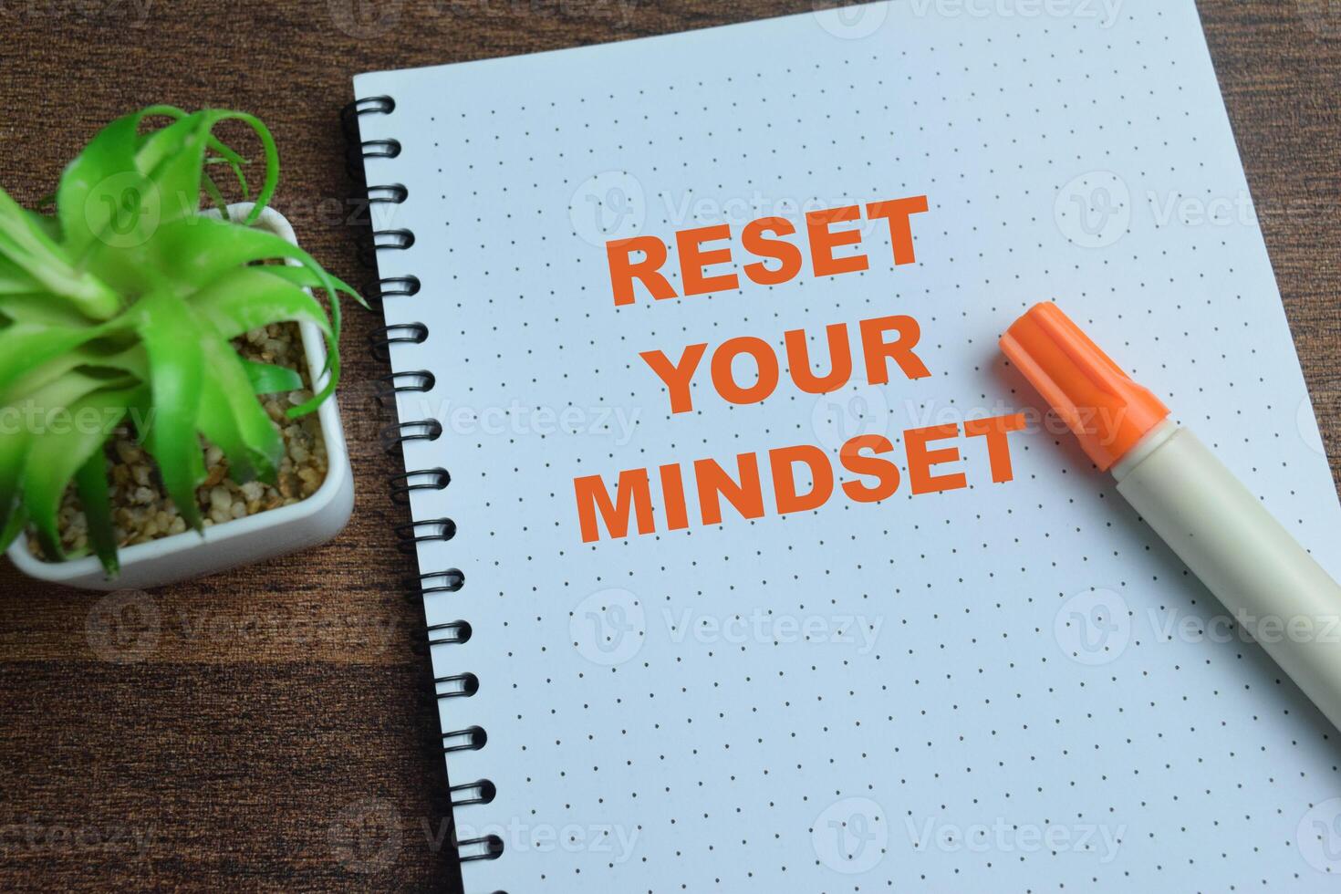 Concept of Reset Your Mindset write on book isolated on Wooden Table. photo