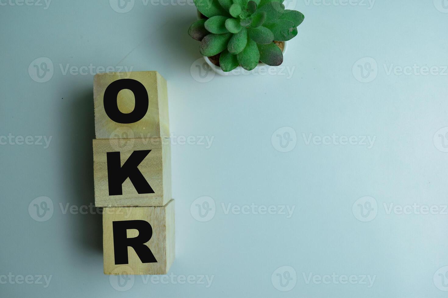 Concept of The wooden Cubes with the word OKR on wooden background. photo