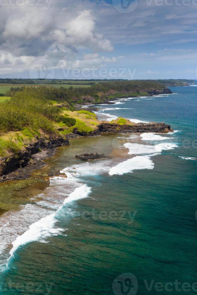 View of the famous Golden beach between black volcanic rocks on the banks of the Gris-Gris river, La Roche qui pleure in Mauritius photo