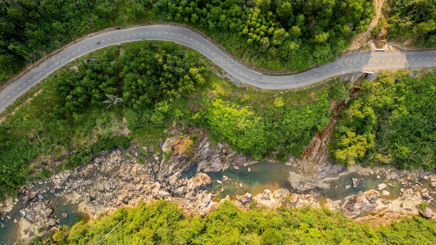 Aerial Winding Road in Tropical Forest photo