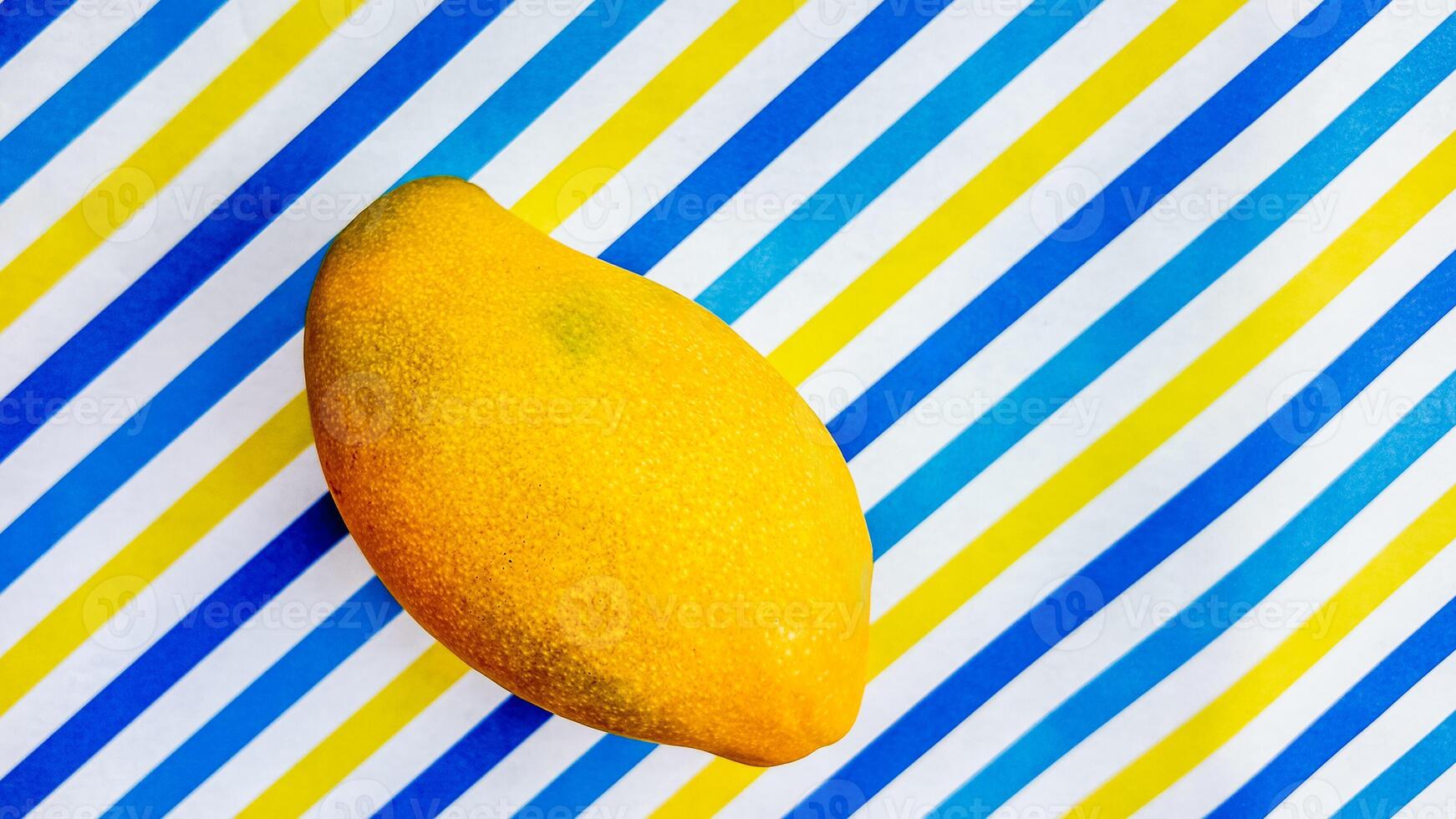 Juicy Mango on Striped Background   Summer Freshness photo