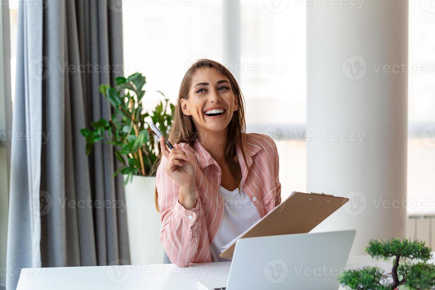 Focused business woman using laptop at home, looking at screen, chatting, reading or writing email, sitting on couch, female student doing homework, working on research project online photo