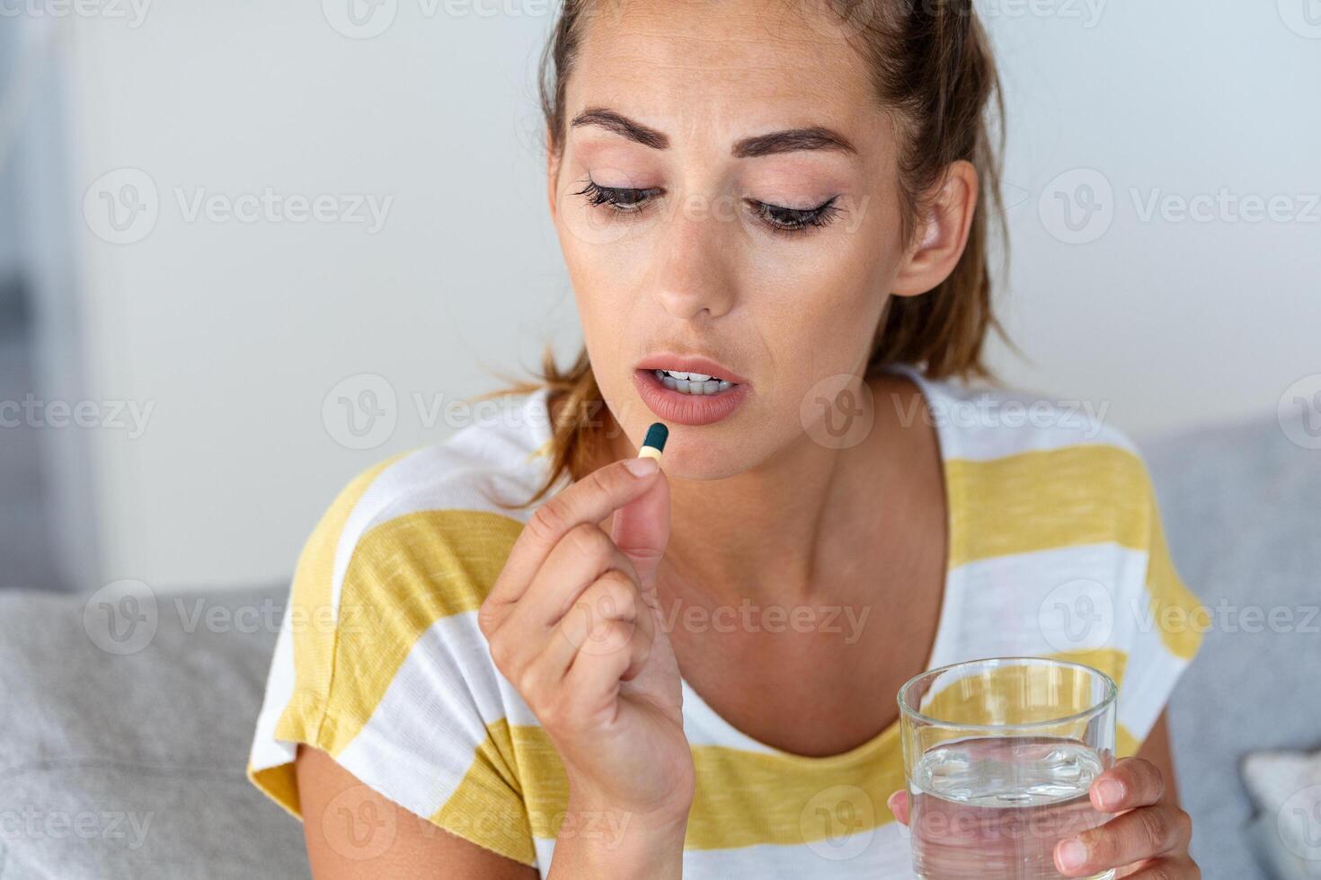 Woman takes medicines with glass of water. Daily norm of vitamins, effective drugs, modern pharmacy for body and mental health concept photo