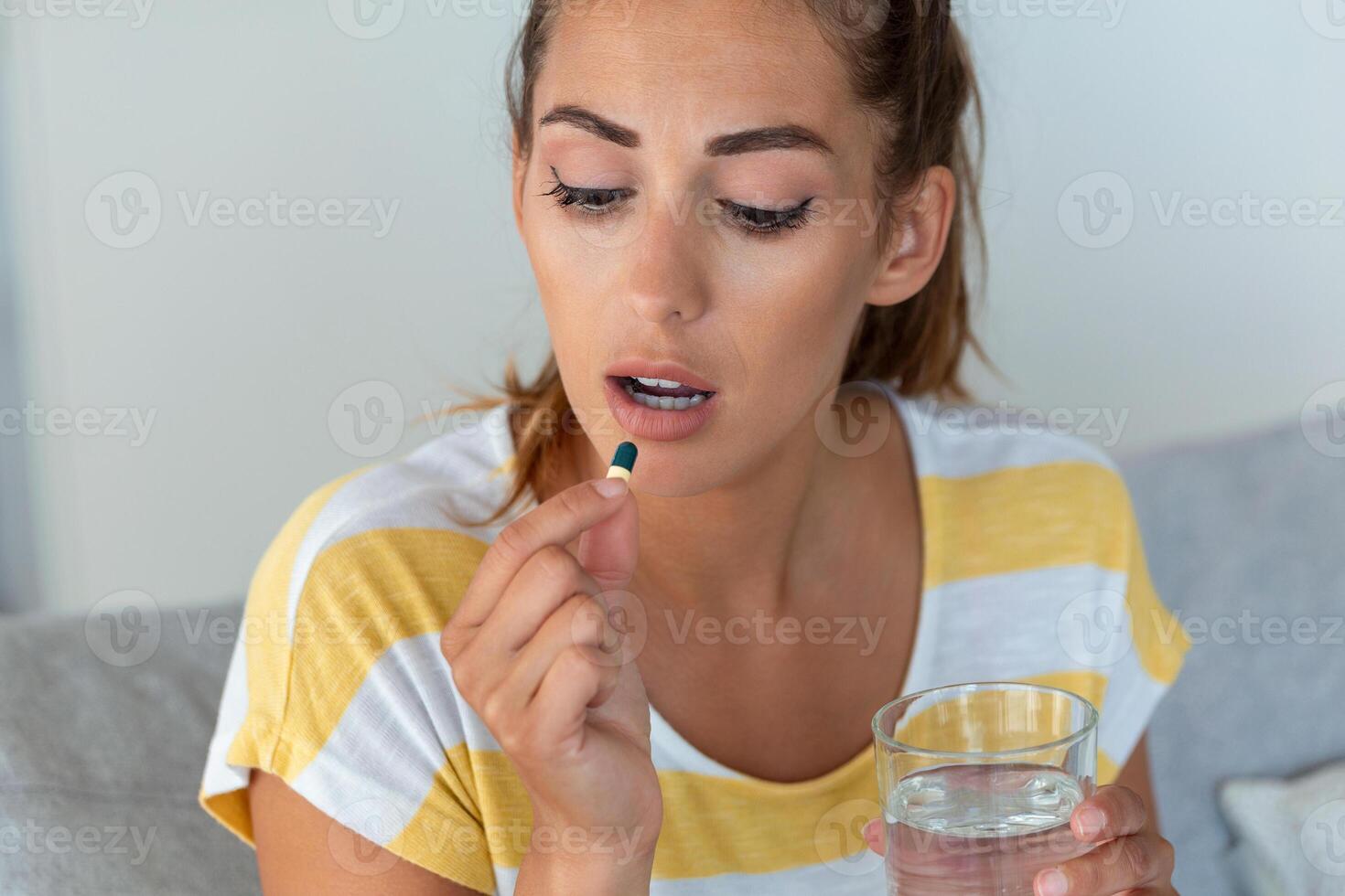 Woman takes medicines with glass of water. Daily norm of vitamins, effective drugs, modern pharmacy for body and mental health concept photo