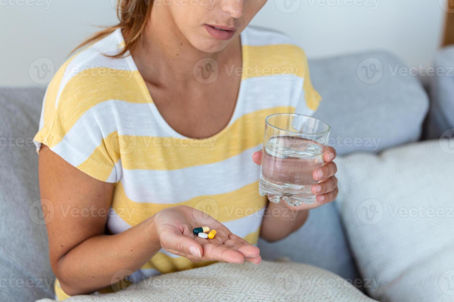 Woman takes medicines with glass of water. Daily norm of vitamins, effective drugs, modern pharmacy for body and mental health concept photo