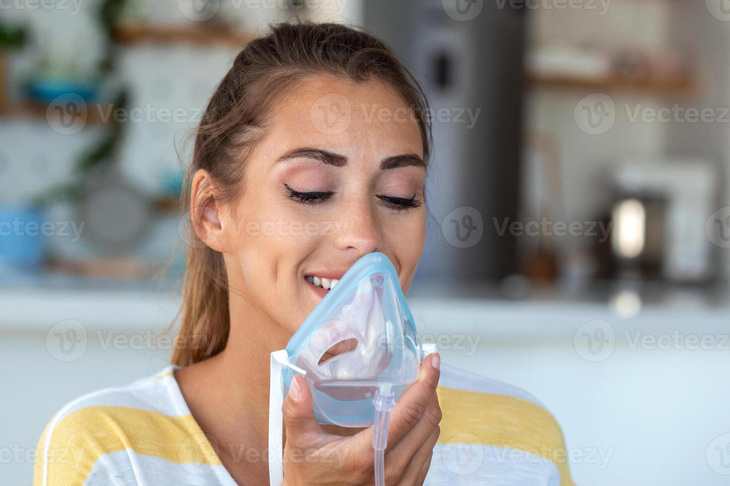 Sick woman making inhalation, medicine is the best medicine. Ill woman wearing an oxygen mask and undergoing treatment for covid-19. woman with an inhaler photo