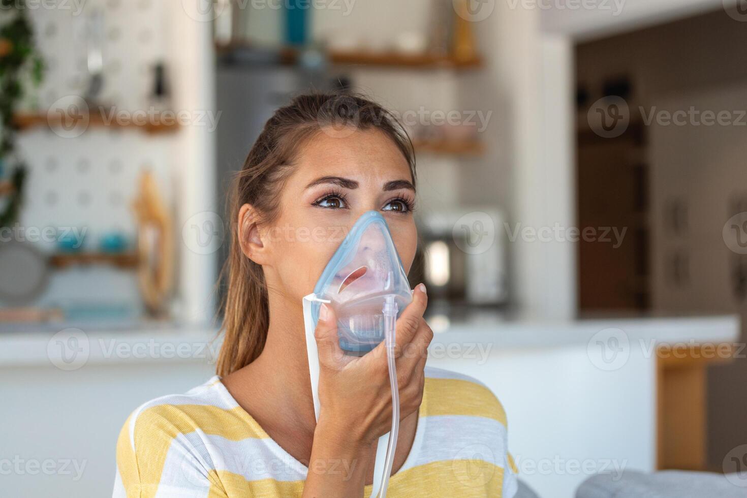 Sick woman making inhalation, medicine is the best medicine. Ill woman wearing an oxygen mask and undergoing treatment for covid-19. woman with an inhaler photo