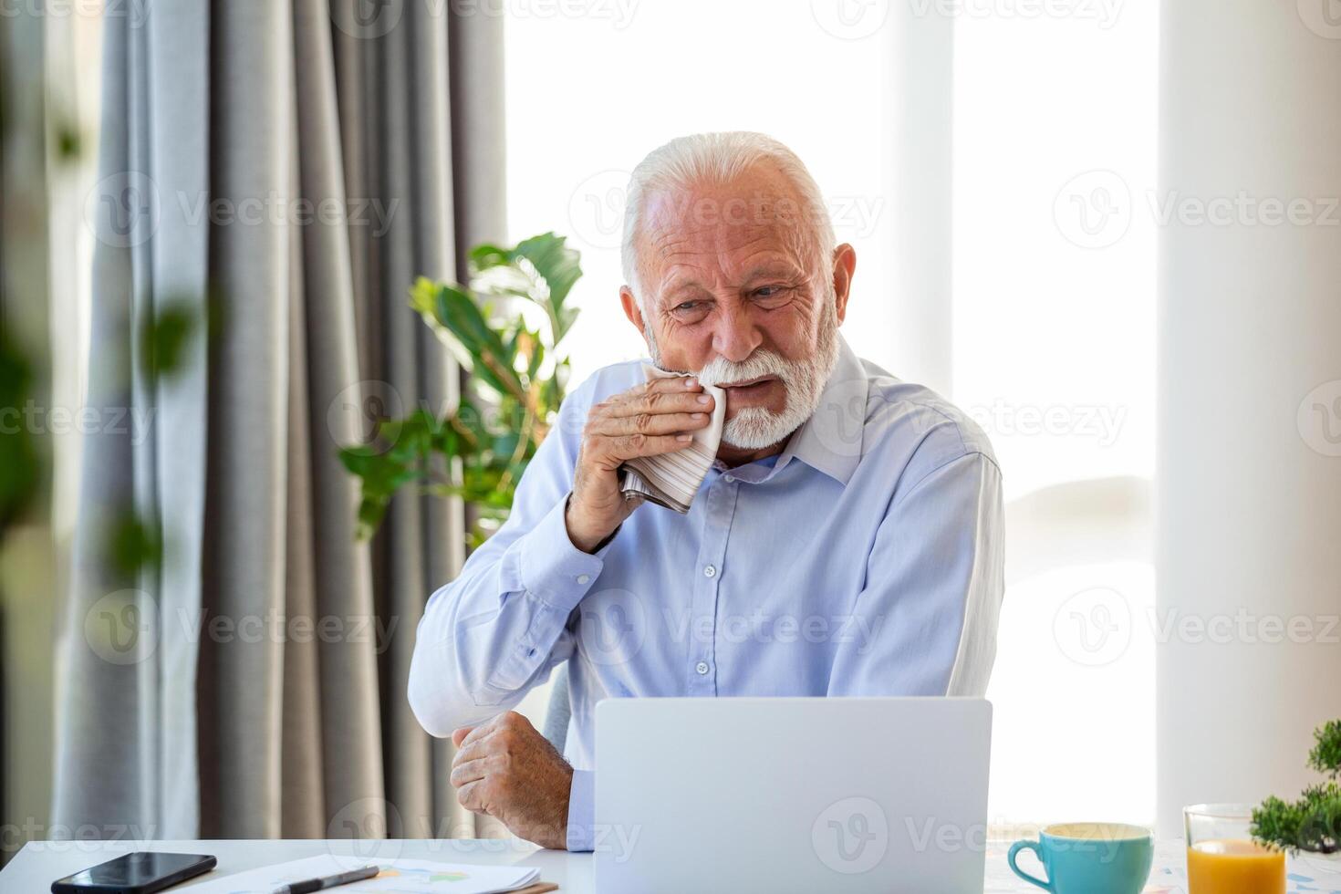 Senior businessman crying working and sitting all day using laptop computer or notebook suffering headache sick worker overworking concept photo