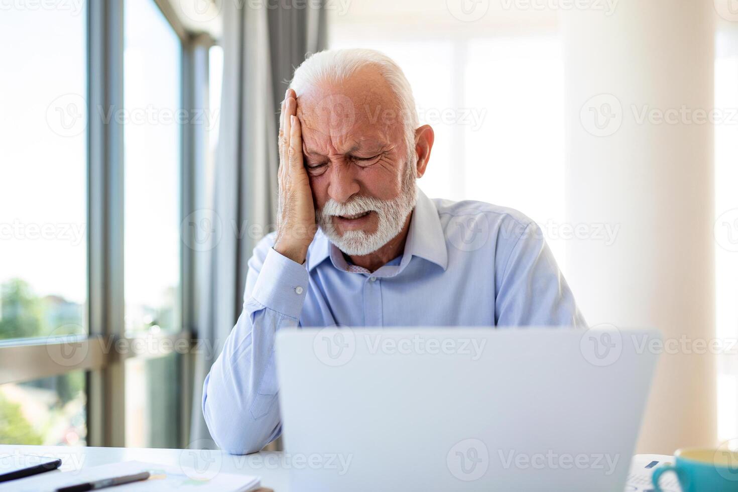 Businessman office working holding sore head pain from desk working and sitting all day using laptop computer or notebook suffering headache sick worker overworking concept photo