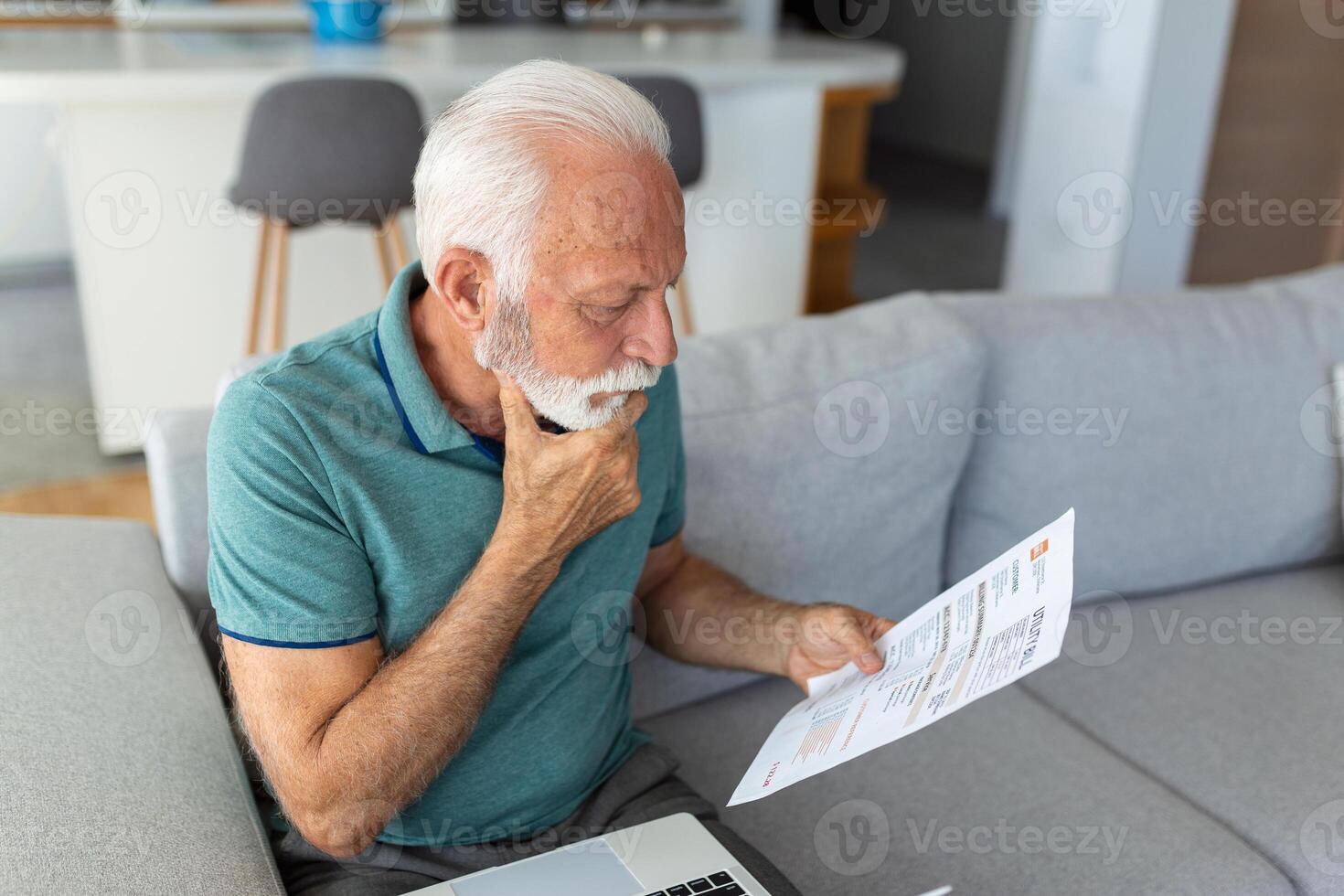 man worried about his monthly payments. Serious senior man holding letter feels interested read business news, got invitation, learns bank statement information. Postal correspondence concept photo