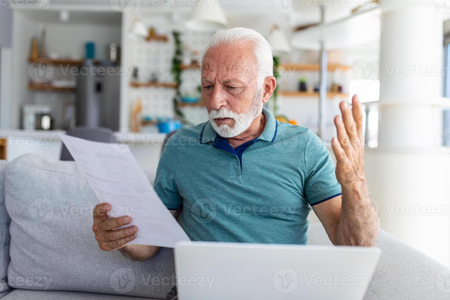 man worried about his monthly payments. Serious senior man holding letter feels interested read business news, got invitation, learns bank statement information. Postal correspondence concept photo