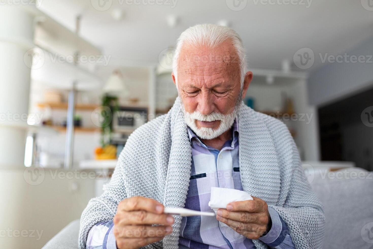 New coronavirus CoVid-19 outbreak situation with pandemic epidemic warning - adult caucasian senior old man with fever symptoms like illness cold seasonal influenza - people and virus concept photo