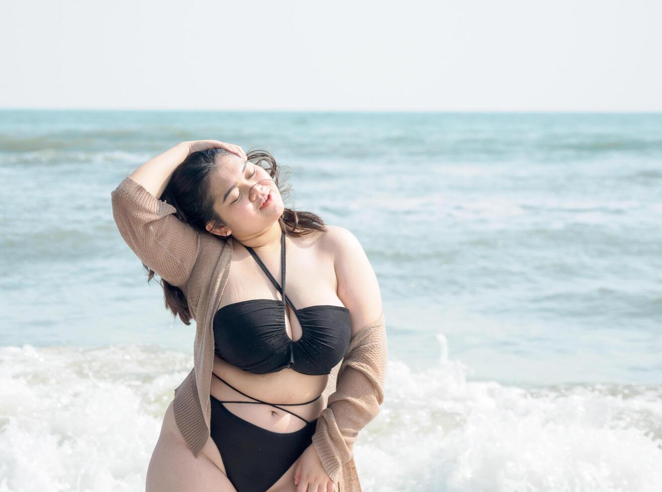 Portrait young asian woman fat chubby cute beautiful smile happy fun enjoy relax bikini swimwear body sexy front view sea beach white sand clean bluesky calm nature ocean wave water travel on holiday photo