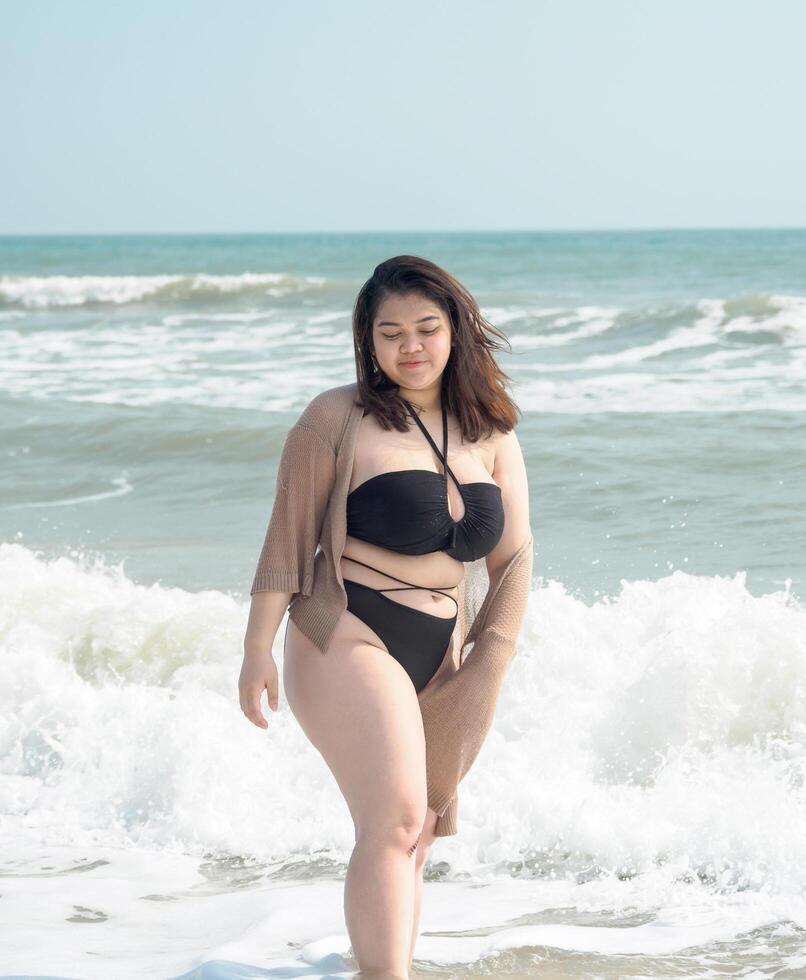 retrato joven asiático mujer grasa gordito linda hermosa sonrisa contento divertido disfrutar relajarse bikini trajes de baño cuerpo sexy frente ver mar playa blanco arena limpiar cielo azul calma naturaleza Oceano ola agua viaje en fiesta foto