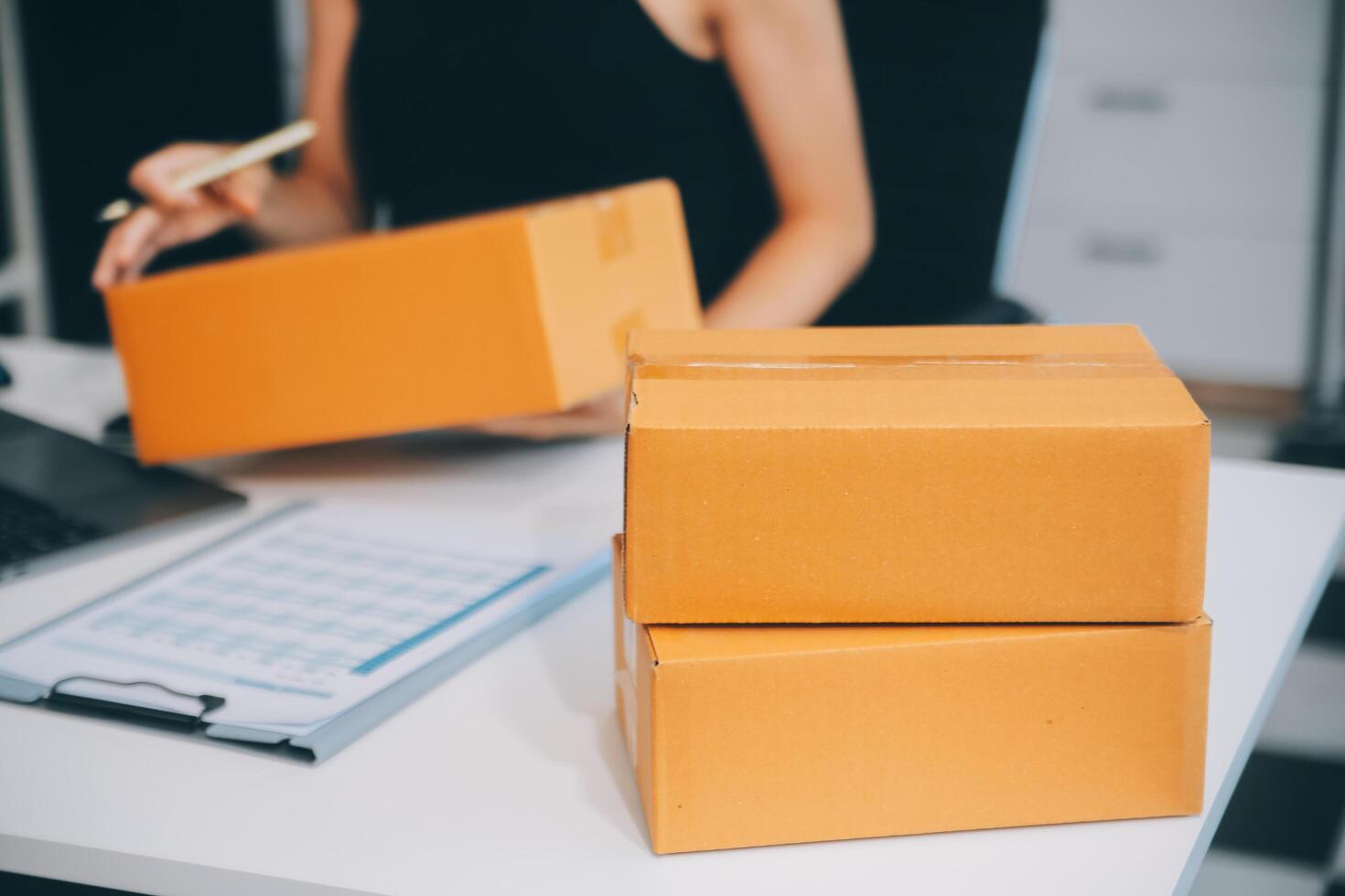 businesswoman start small business and successful SME entrepreneurs asian woman hoding boxs works from home delivering parcels online. SME delivery concept and packaging photo