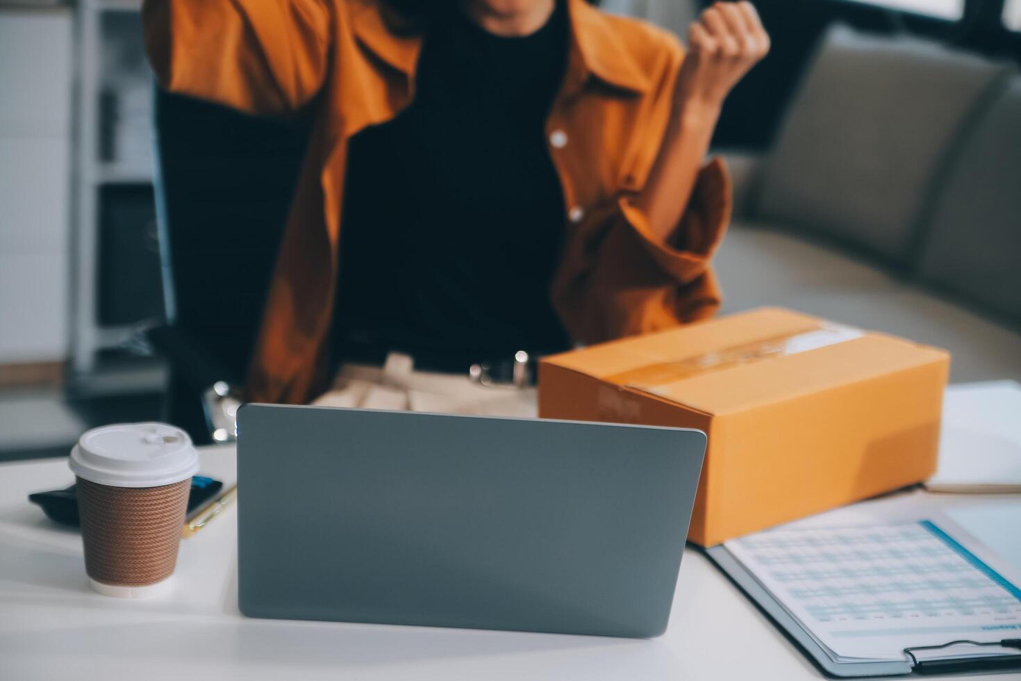 businesswoman start small business and successful SME entrepreneurs asian woman hoding boxs works from home delivering parcels online. SME delivery concept and packaging photo