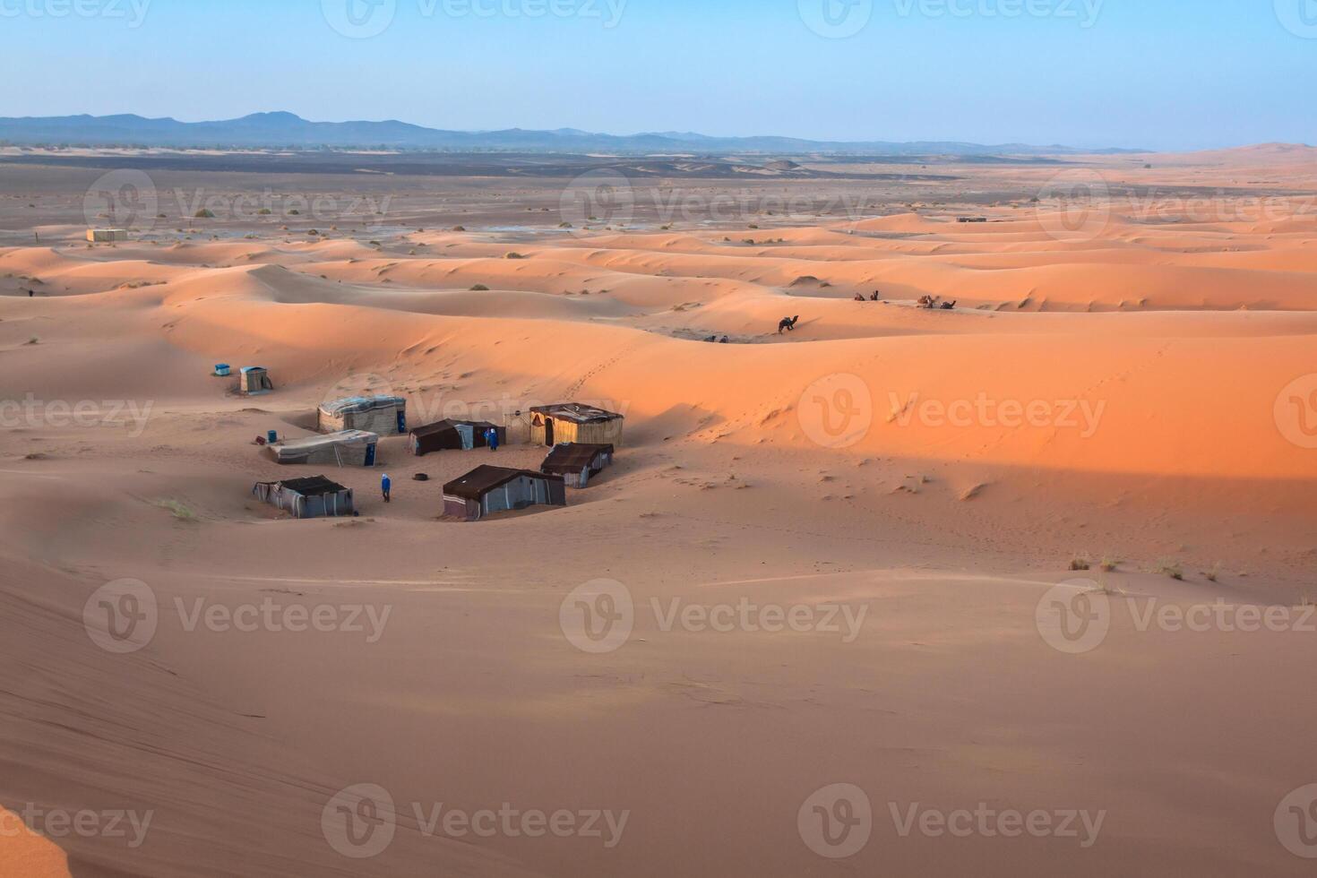 Tent camp for tourists in sand dunes of Erg Chebbi at dawn, Morocco photo