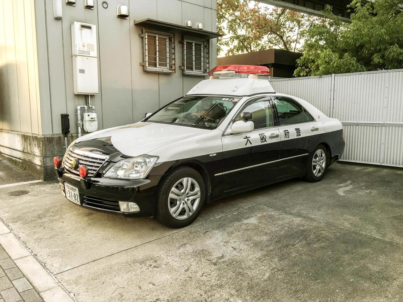 Osaka city, Japan, 2016 - Japanese police car parked be side police boot and car parking. photo