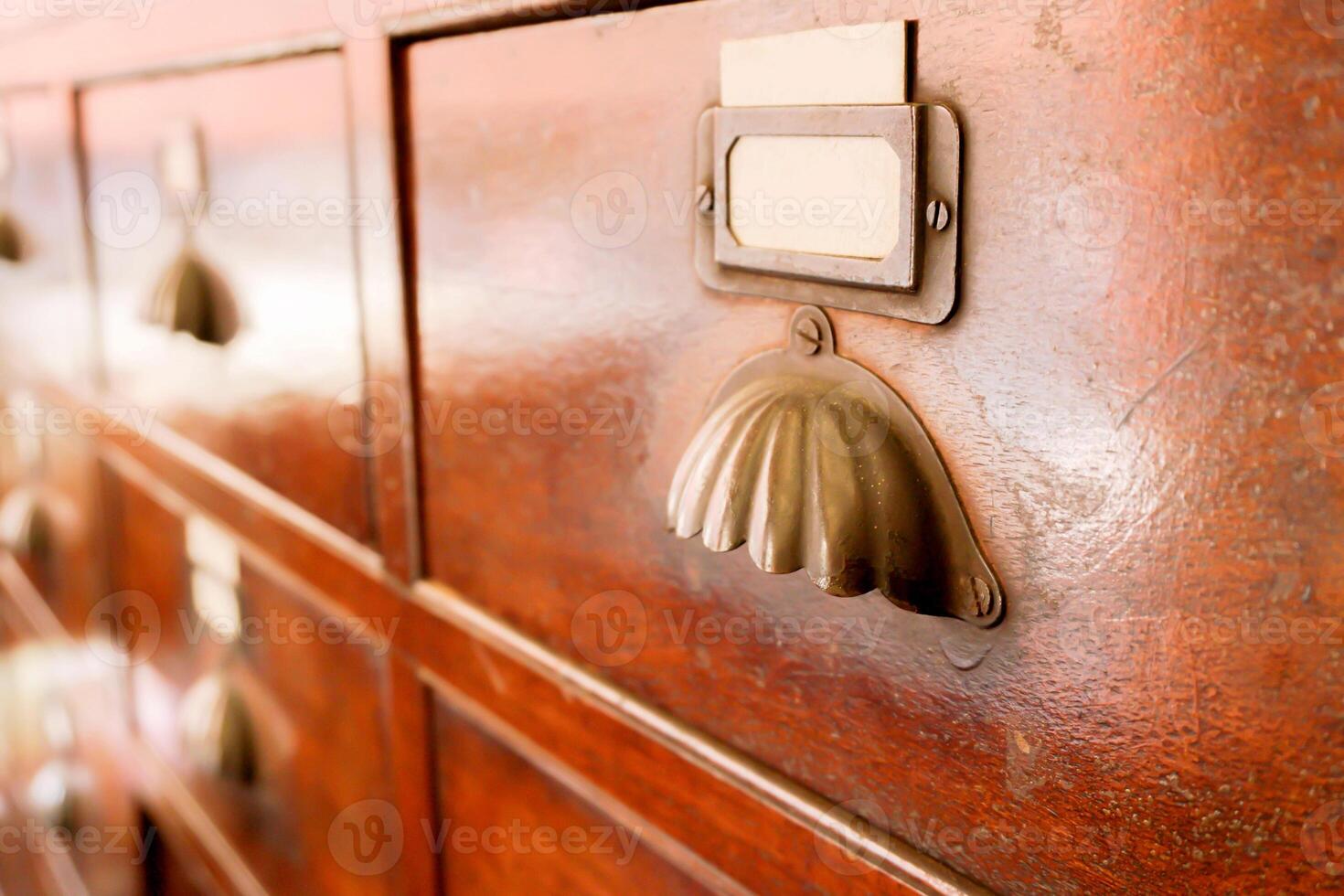 Perspective view and closeup of ancient wooden drawer in Chinese herbs shop. photo