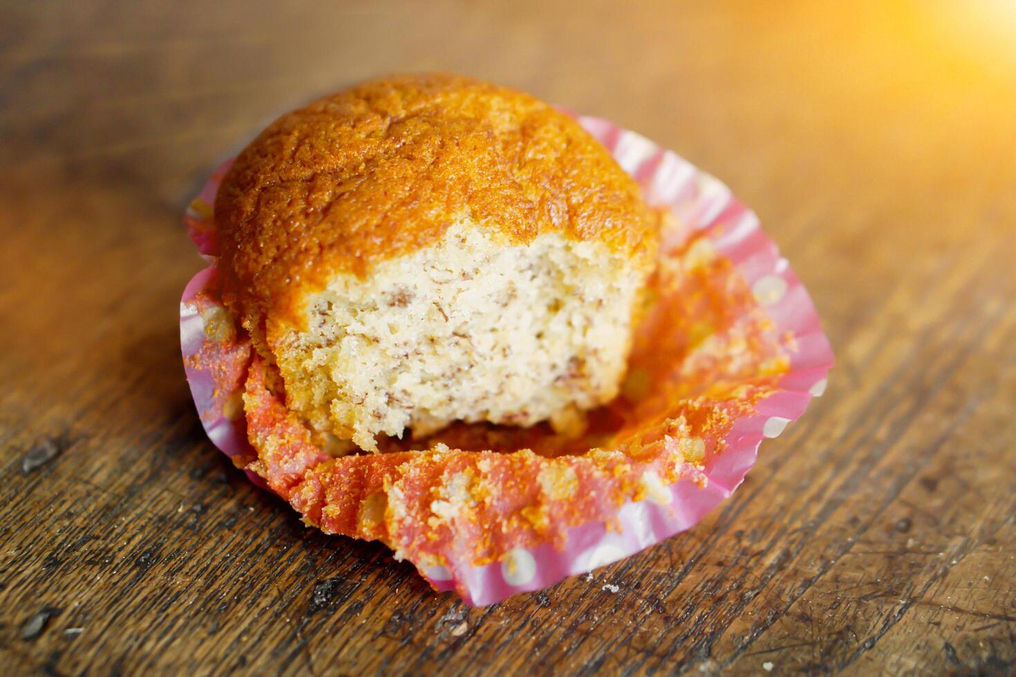 Thai ancient eggs cupcake was eaten put on wooden table and sun flares background. photo