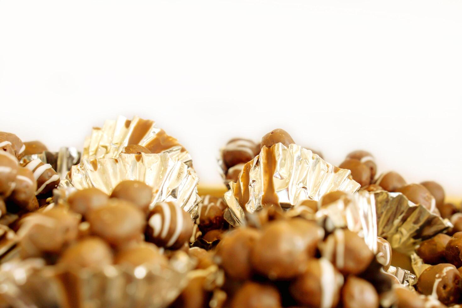 Closeup Chocolate balls with bakery foil on white background in a bakery shop. photo