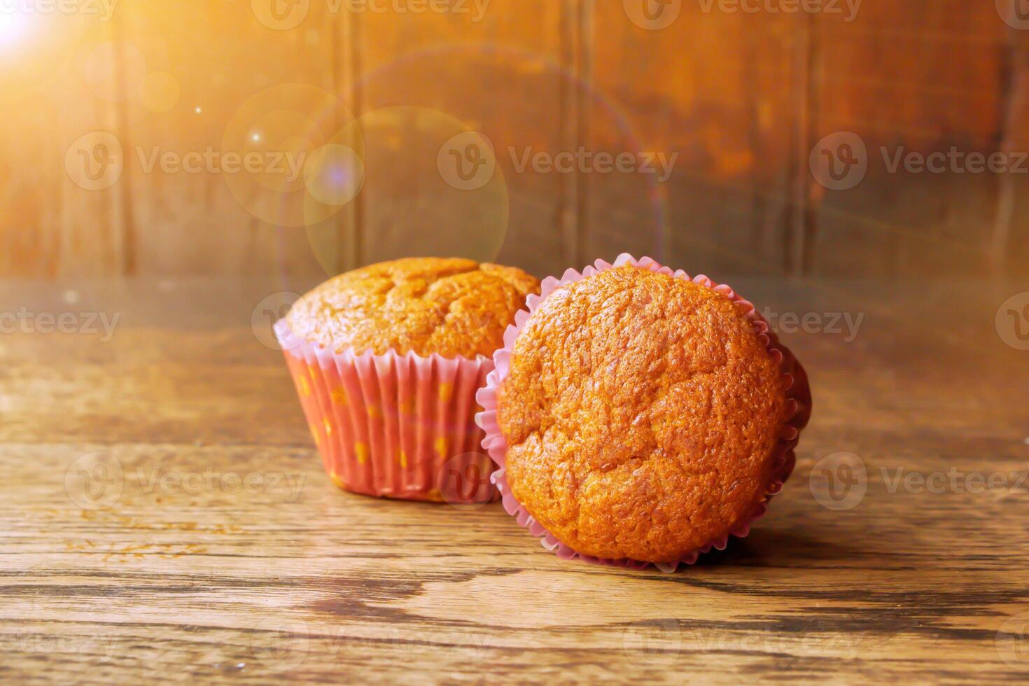 Twin Thai ancient eggs cupcake put on wooden table and background with sun flare and lens flare. photo