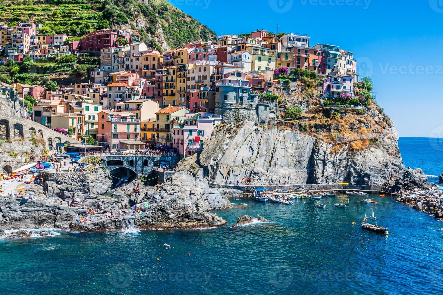 Village of Manarola with ferry, Cinque Terre, Italy photo