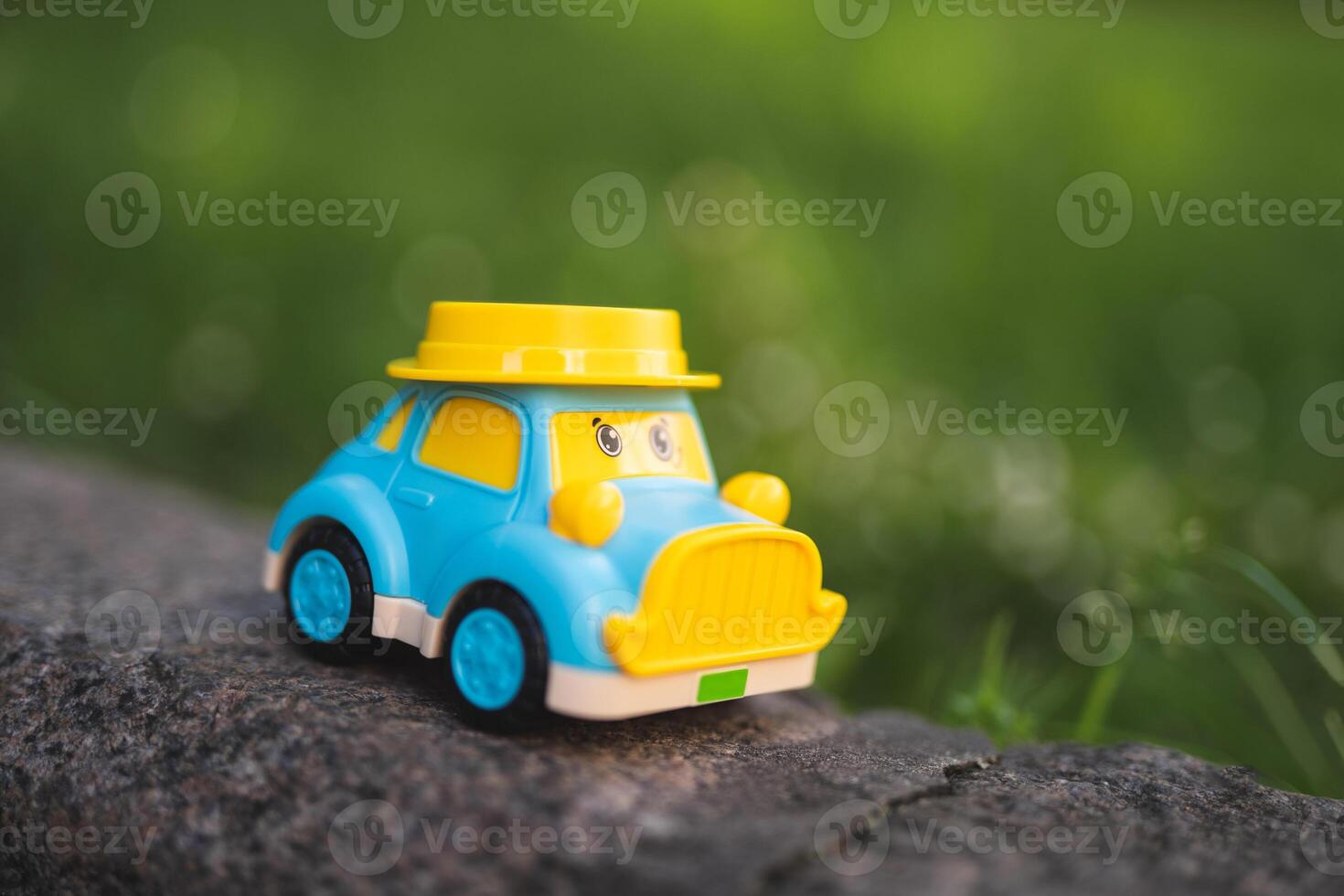 children's plastic toy car with eyes on the playground photo