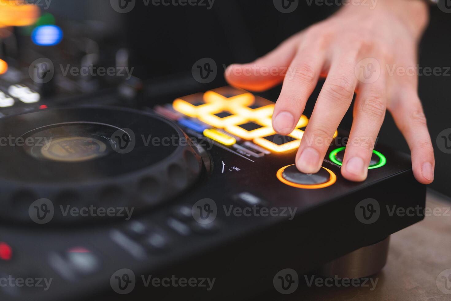 a DJ plays music on a controller at a party photo