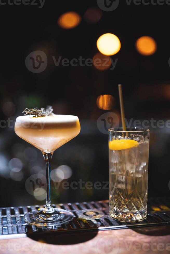 the bartender prepares a beautiful alcoholic cocktail at the bar counter photo