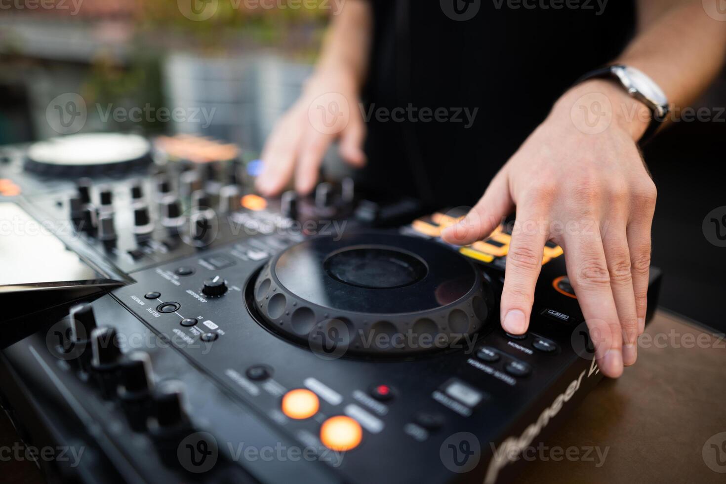 a DJ plays music on a controller at a party photo