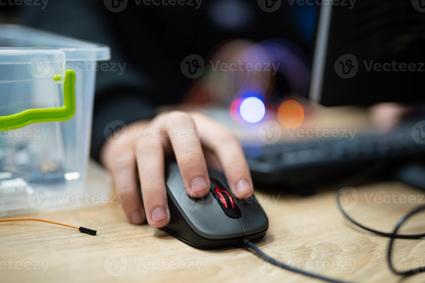 close-up of a hand clicking buttons on a computer mouse photo