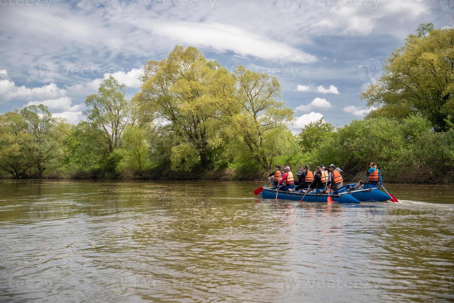a team of athletes on a catamaran overcomes obstacles floating on the river photo