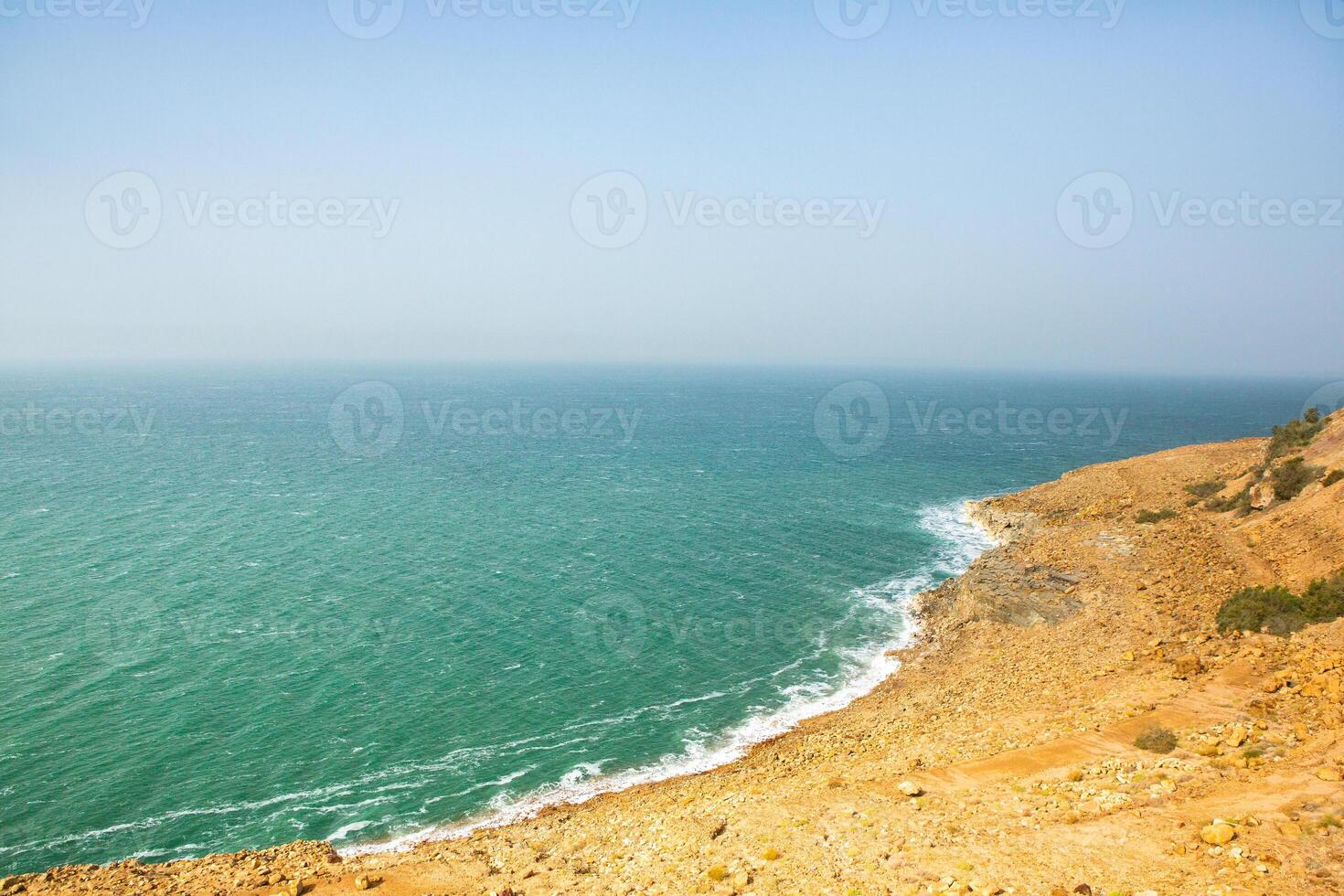 View of Dead Sea coastline at sunset time in Jordan. Salt crystals at sunset. Dead sea landscape with mineral structures. photo