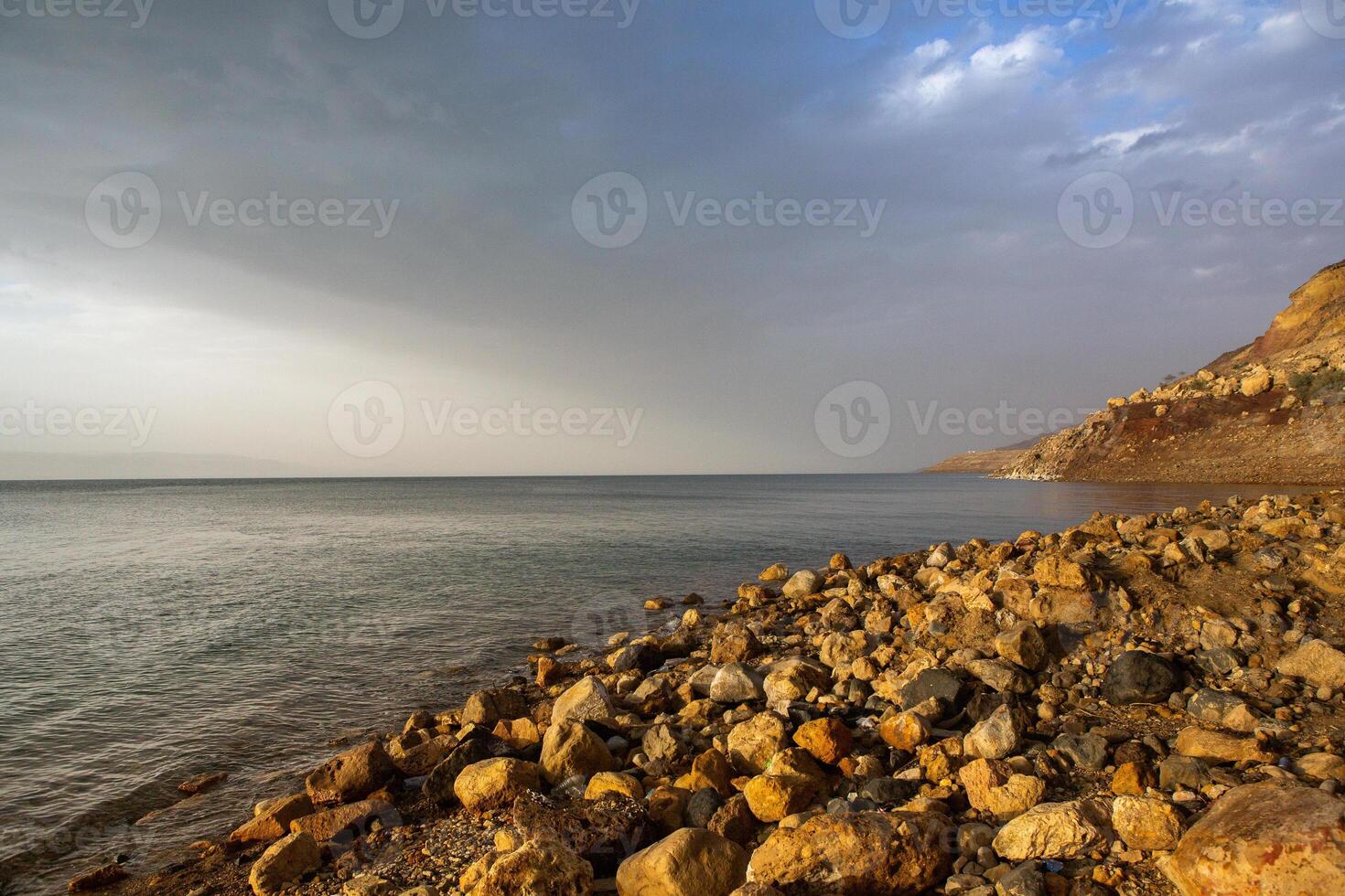 View of Dead Sea coastline at sunset time in Jordan. Salt crystals at sunset. Dead sea landscape with mineral structures. photo