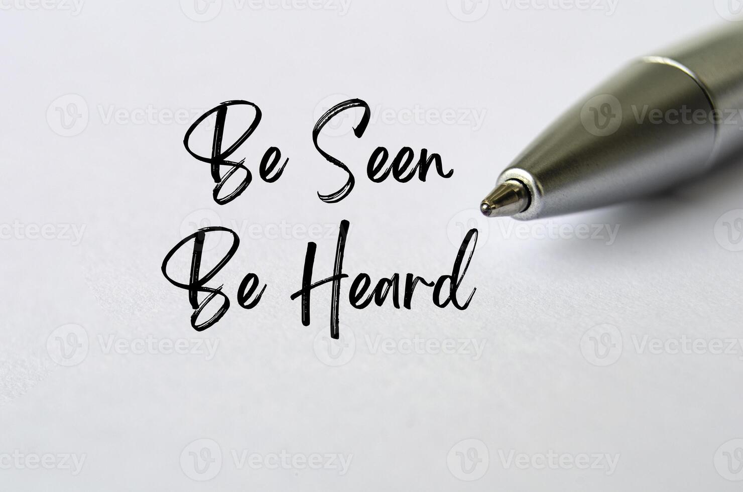 Be Seen Be Heard text with bold pen background. Business concept. photo