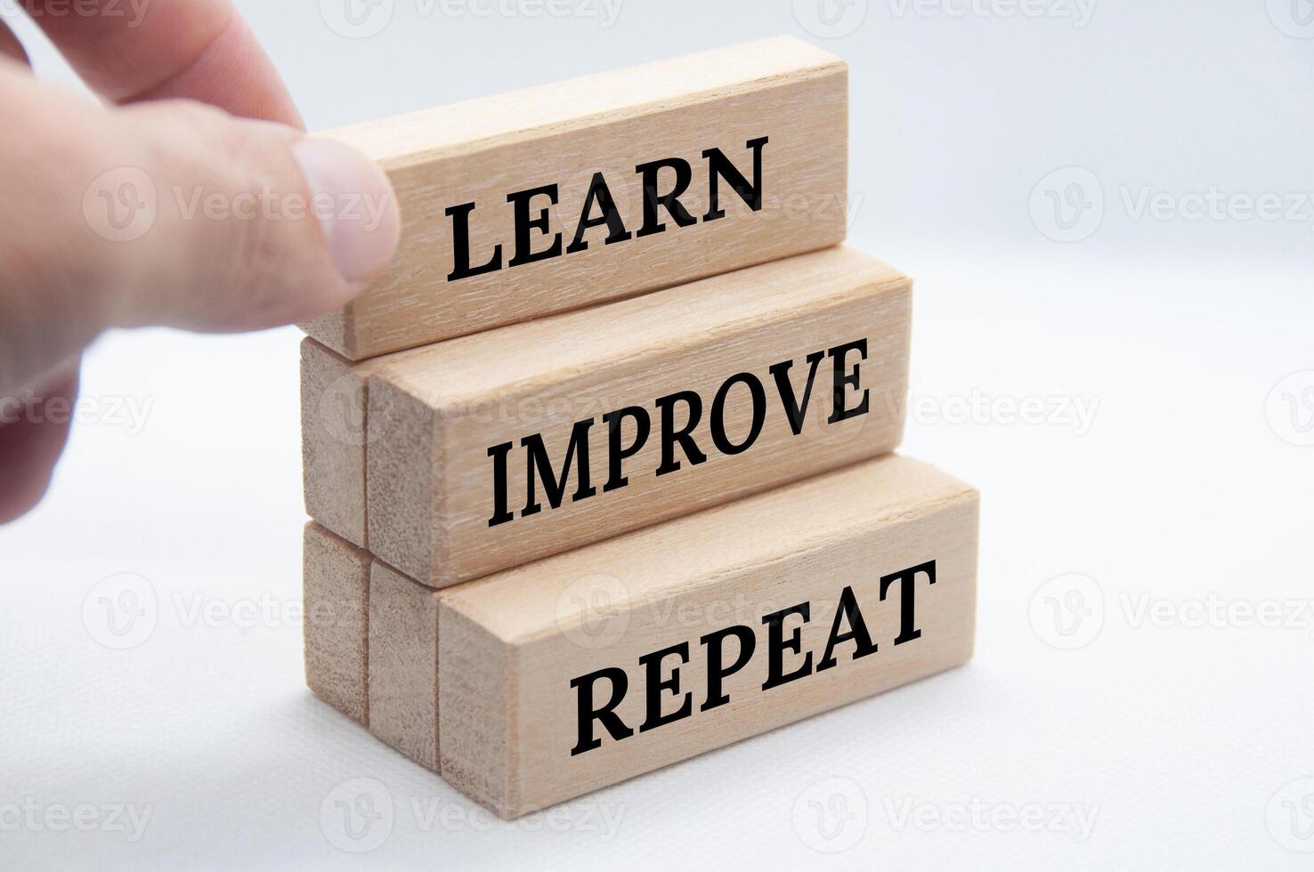 Learn, improve and repeat text on wooden blocks with white cover background. Improvement concept. photo
