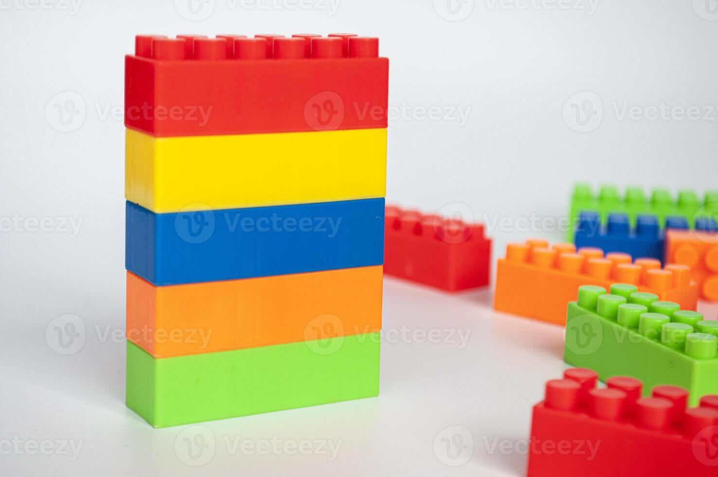 Plastic building blocks on white background. photo